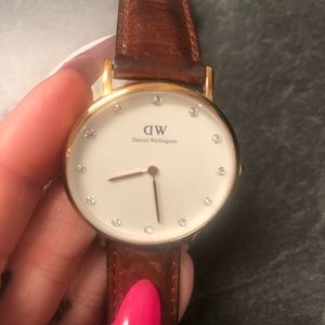 Daniel Wellington, rose gold trim watch with brown leather strap.
